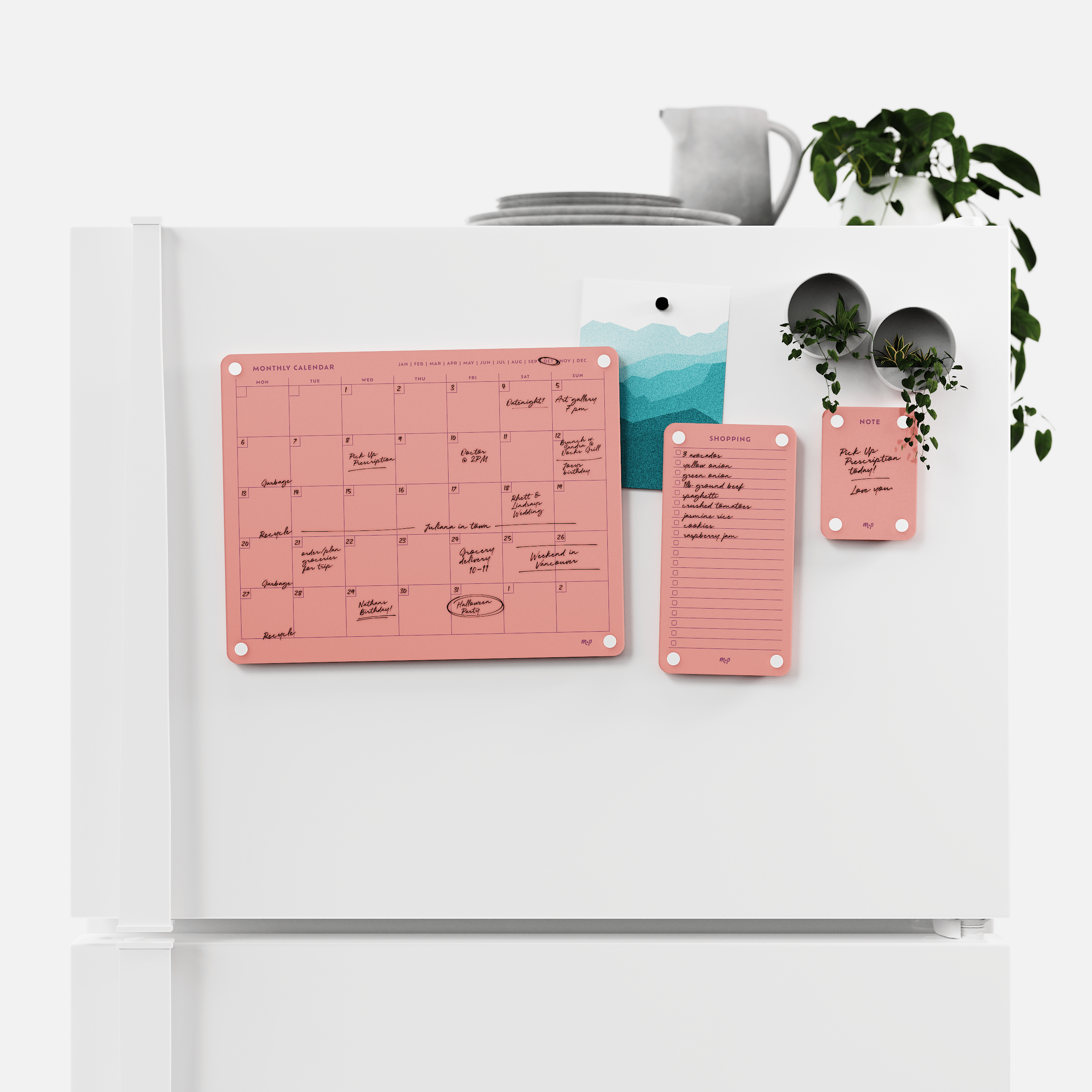 Coral monthly calendar, shopping list and note board magnetised to a white fridge door